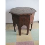 An Islamic octagonal folding table with brass inlay.