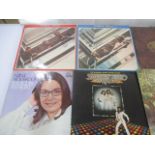 A collection of 12" vinyl records including The Beatles, Carly Simon, Kate Bush, Art Garfunkel, John