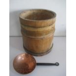 A vintage wooden barrel, along with a copper skimmer