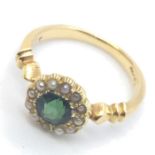 An 18ct gold ring set with tourmaline and seed pearls. Size I