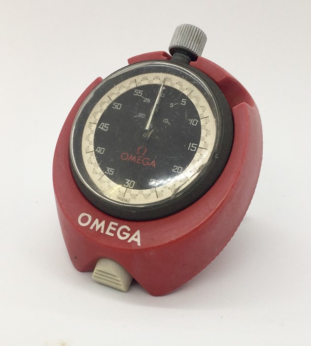 A vintage Omega wind up stop watch in carry stand.