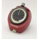 A vintage Omega wind up stop watch in carry stand.