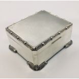 A hallmarked silver cigarette box (hallmark rubbed)
