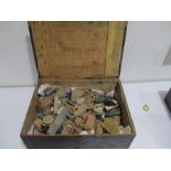 A collection of various metal detecting finds in wooden box