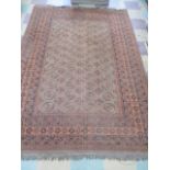 A vintage red ground rug, 250 cm x 177 cm