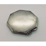 A hallmarked silver octagonal compact.