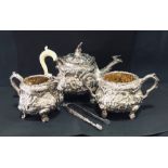 A heavily embossed hallmarked silver tea set consisting of tea pot, cream jug, sugar bowl and