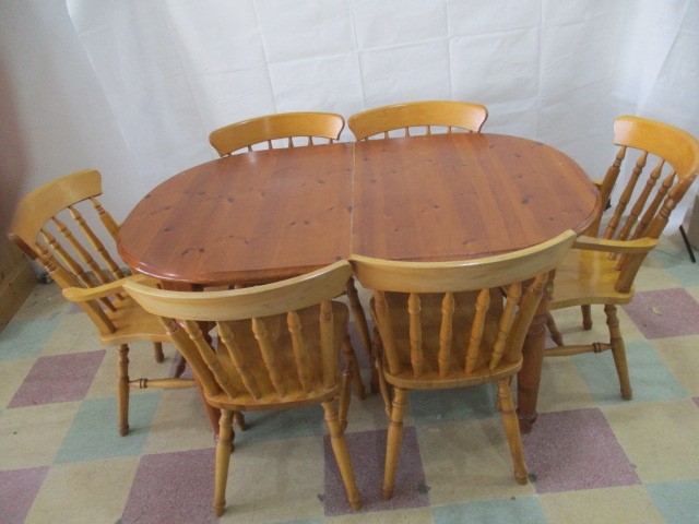 A pine dining table and 6 chairs