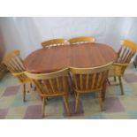 A pine dining table and 6 chairs