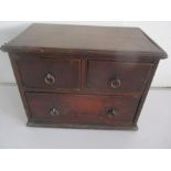 A collectors three draw chest, full of various shells.