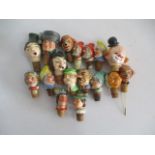 A collection of novelty china bottle stoppers.