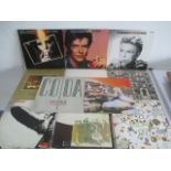A collection of eleven 12" vinyl records including six Led Zeppelin, three David Bowie, one Pink