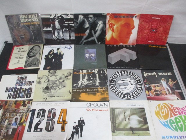 A collection of 7" vinyl singles including The Beatles, Robert Plant, The Jam, Free, Madonna,