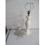 A large alabaster table lamp along with a glass chandelier with drops