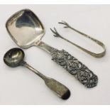 A Danish 830 silver spoon marked NM along with a silver salt spoon and sugar nips