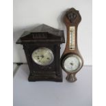 A wooden cased mantle clock along with a barometer