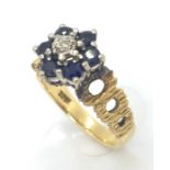 An 18ct gold ring with central diamond and sapphire surround