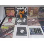 A collection of vinyl records including The Beatles, Led Zeppelin, David Bowie, Black Sabbath, U2,