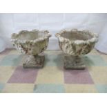 A pair of concrete garden pots