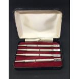 A cased set of 4 Sterling silver bridge pencils