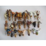 A collection of novelty animal bottle stoppers including dogs, parrots, horses etc