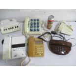 A collection of seven vintage telephones.