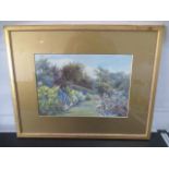 An unsigned framed watercolour of a garden