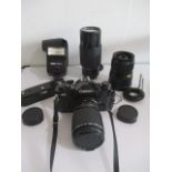 A Canon A-1 camera with various zoom lenses, flash and power winder etc.