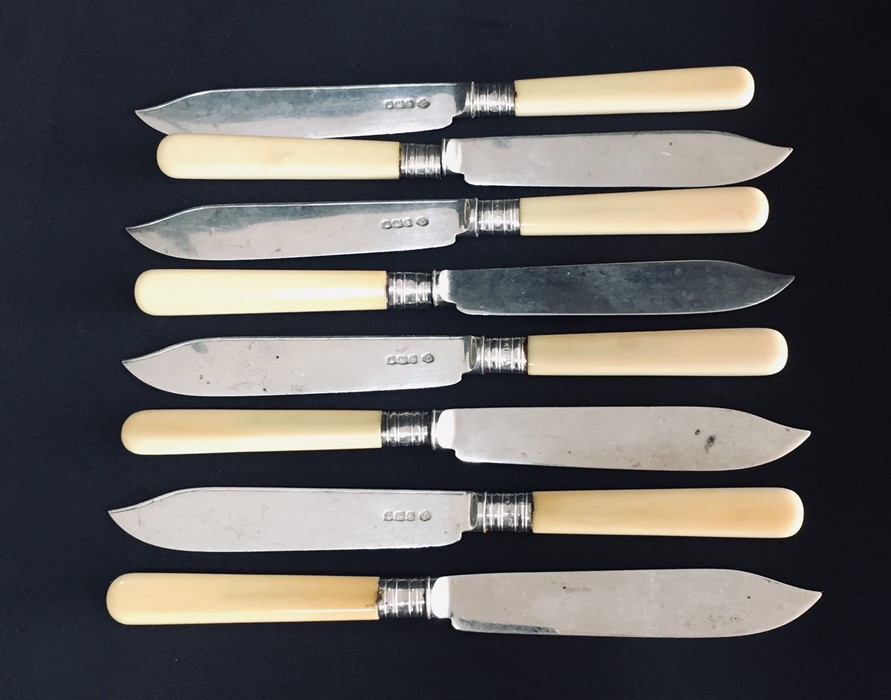 A set of eight silver bladed fish knives
