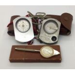 A Suunto compass and clinometer along with a map wheel