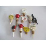A collection of ten advertising bottle stoppers including Mackinlay's old scotch whisky, Walkers