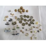 A small collection of vintage cufflinks, coins, studs and military buttons