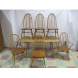 An Ercol blonde dining table along with six chairs, including two carvers.