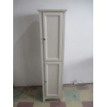 A narrow Reggar two door white cupboard