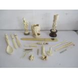 A collection of carved bone ornaments along with faux ivory etc.