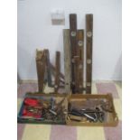 A collection of various tools including drill bits, spirit levels, saws etc