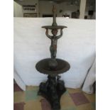 A Victorian style cast iron fountain with stylised dolphin base, acanthus leaf bowls with cherub