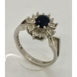 An 18ct white gold diamond and sapphire cluster ring