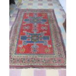 A red ground rug with geometric pattern - 300cm x 190cm