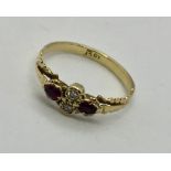 An 18ct gold diamond and ruby ring. Size O