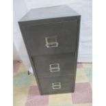 A metal filing cabinet with three drawers - no key