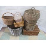 A quantity of wicker items including a log bin, picnic hamper, planter, trays, carry baskets etc