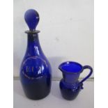 A Georgian Bristol blue "Rum" decanter, height 22cm along with a small blue glass jug