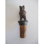 A vintage Black Forest wood carved bear bottle stopper