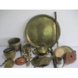A collection of various brassware and copperware items, including candlesticks, bed warmer, kettle
