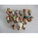 A collection of novelty china bottle stoppers.
