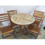 A teak garden table and four chairs