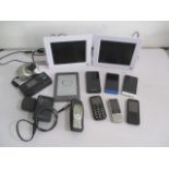 A collection of electronic's including a Kindle, mobile phones, Nikon camera, digital day clocks