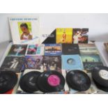 A collection of 7" vinyl records including Slade, Phil Collins, Freddie Mercury, Paul McCartney,