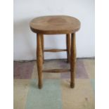An elm stool, height 58.5 cm
